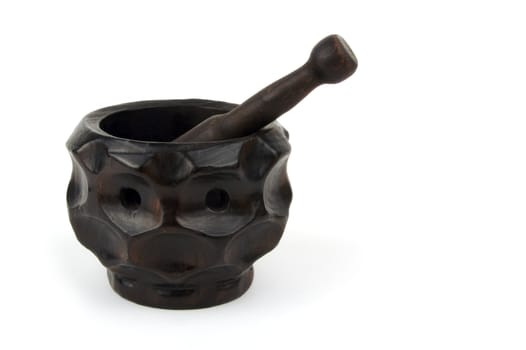 Wood mortar and pestle on a white background.