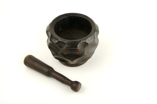 Wood mortar and pestle on a white background.