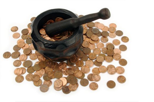 Grinding for Pennies - Wood mortar and pestle containing pennies bills on a white background.