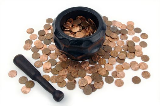 Grinding for Pennies - Wood mortar and pestle containing pennies bills on a white background.