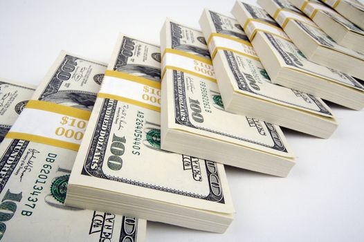 Stacks of Hundred Dollar Bills on a white background.