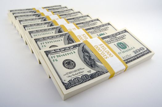 Stacks of Hundred Dollar Bills on a white background.