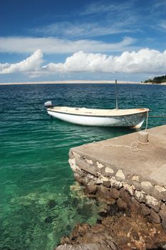 Motor boat lying on calm waters on sunny day