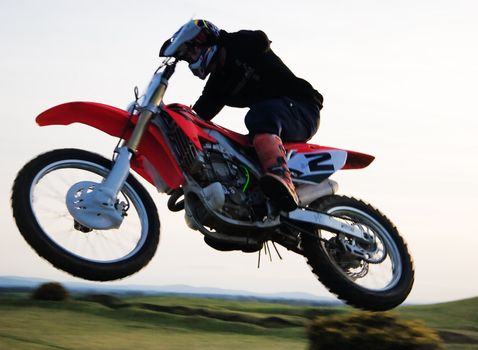 Motor cross rider jumping through the air