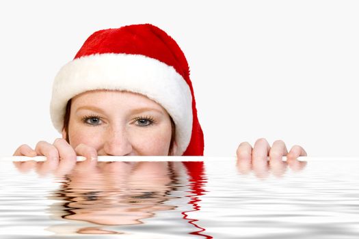 Portrait of a cute christmas fearie who is looking over the edge of a pool.