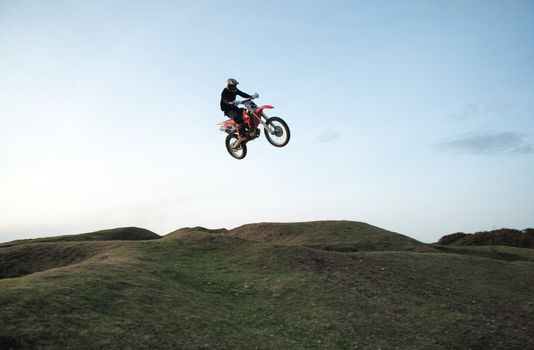 Motor cross rider jumping through the air