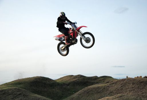 Motor cross rider jumping through the air