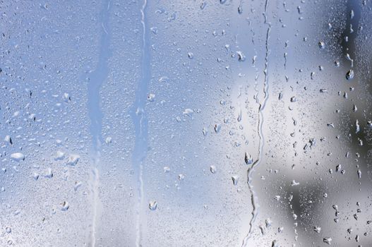 Rain Drops on Window as the clouds clear behind.