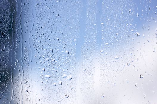 Rain Drops on Window as the clouds clear behind.