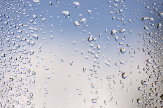 Rain Drops on Window as the clouds clear behind.