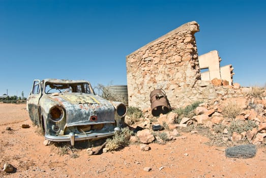 great image of an old car rusting away in the desert
