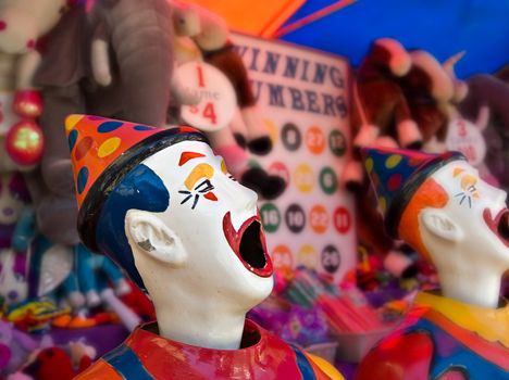 sideshow clowns with big mouths at the funfair