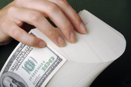 Woman fanning Large Stack of One Hundred Dollar Dollar Bills