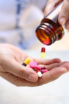 medical pills in a hand poured from a bottle container