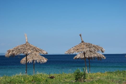 greece sea with blue sky and sunshade, horizontally framed shot