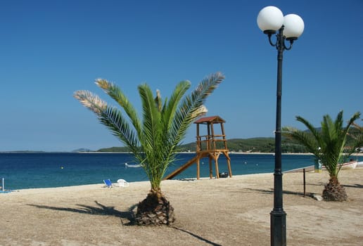 greece sea with blue sky, lamp, palm, horizontally framed shot