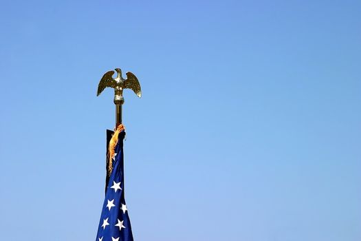 The top of a USA flag with a golden eagle