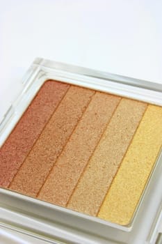 Makeup, eye shadow, a set of earth yellow shades on white background