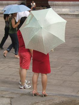 Chinese girls with red dress and one umbrella