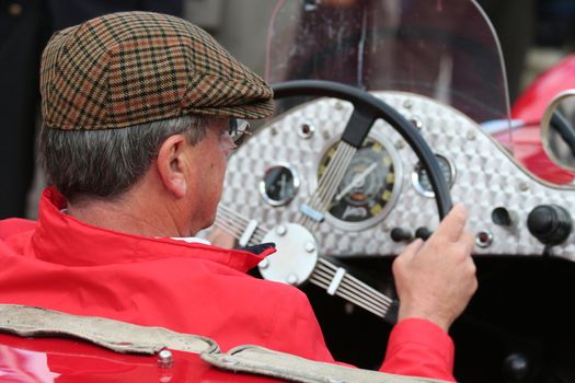 Man in a retro automobile on a show