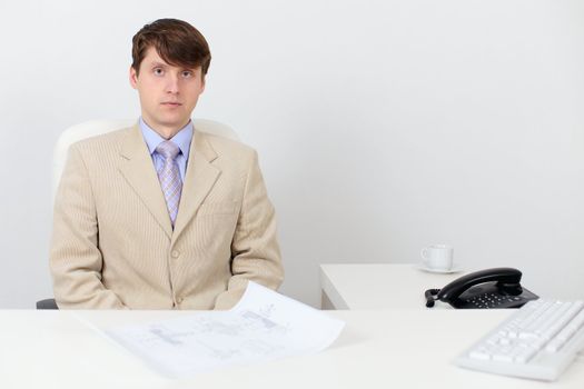 A serious man in a business suit at work in the office