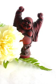 Buddha with white carnation on white background