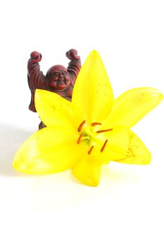 Red Buddha Statue with yellow Lily flower.