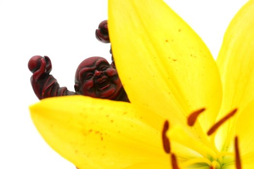 Red Buddha Statue with yellow Lily flower.