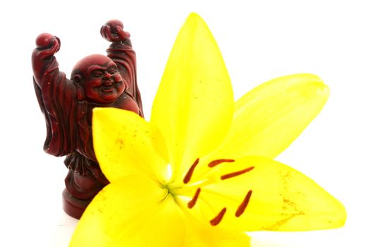 Red Buddha Statue with yellow Lily flower.