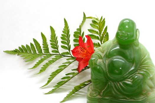 Green buddha with leaves and flowers