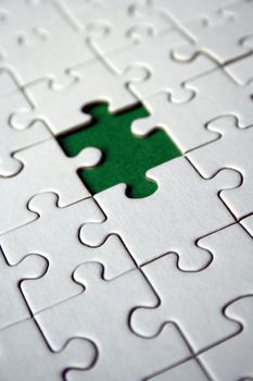 White jigsaw pattern with one green empty space