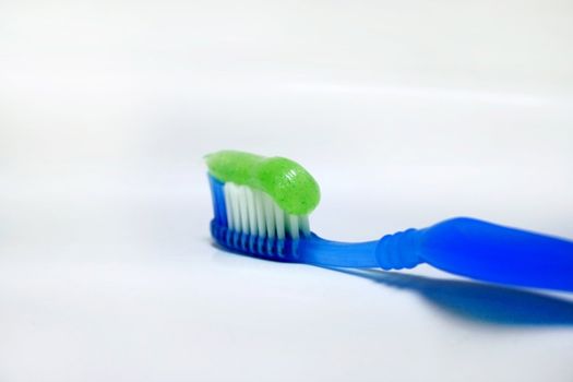 toothbrush with paste for cleaning teeth on background of the washstand