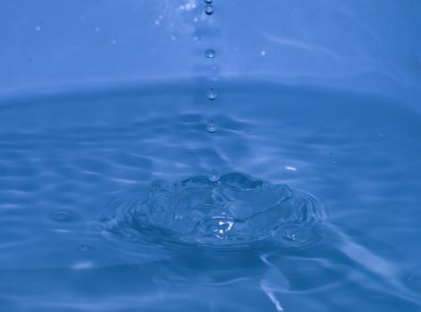 splash of blue water with small drops motion