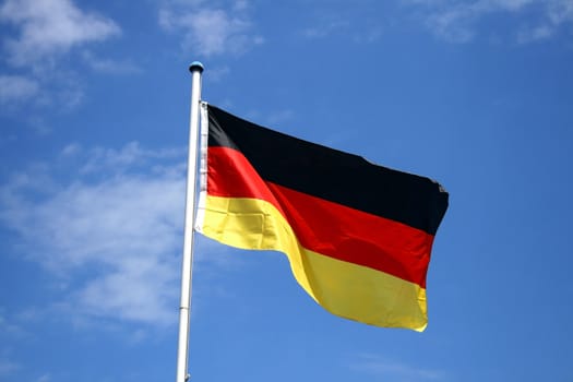 a german flag in front of clouds