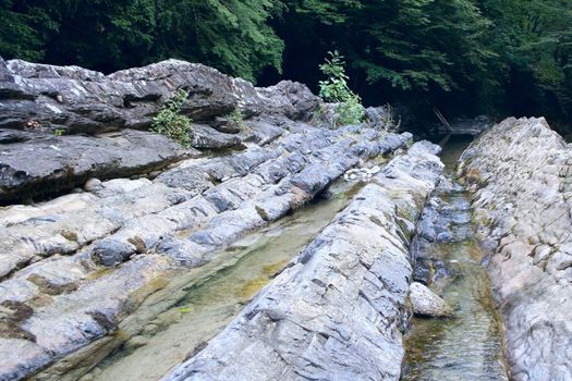 tempestuous clean mountain river with waterfall in stone granite break