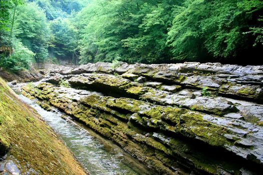 tempestuous clean mountain river with waterfall in stone granite break