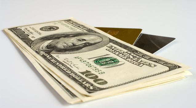 Credit cards and dollars on a white background.