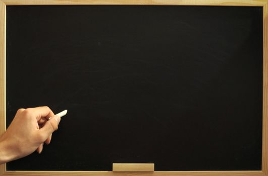 blank and empty chalkboard with hand and copyspace for text