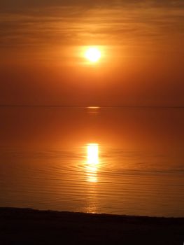 Orange sunset above a quiet serene gulf