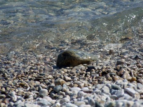 Wet pebble in waves of the Black Sea 1