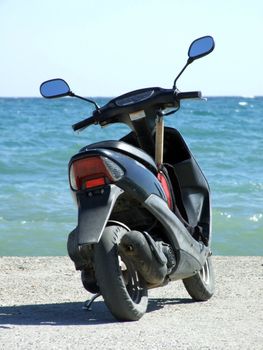 motorbike on a mooring on a background of the blue sea