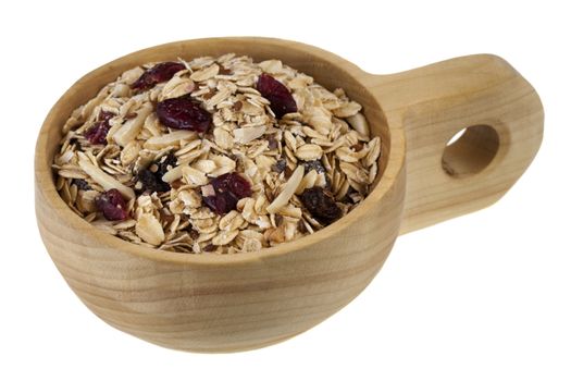 muesli cereal in (rolled oats with raisins, cranberries, slices almonds and flax seeds) on a rustic wooden scoop or bowl isolated on white