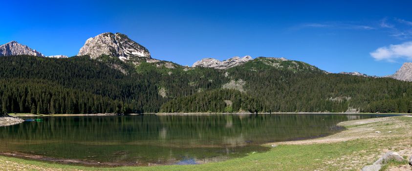 panorama of mountain lake with evergreen forast around