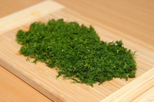 A cutting dill on the chopping board