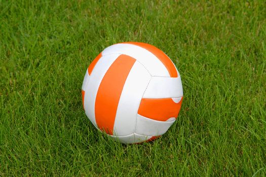 Orange and white ball on the green