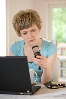 young woman working on a laptop, indoors, shallow DOF