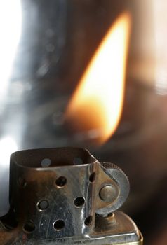 Really great macro photo of a zippo lighter. Sharp close-up and stunning flame.