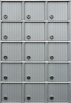 Rows of metallic mailboxes with numbers.