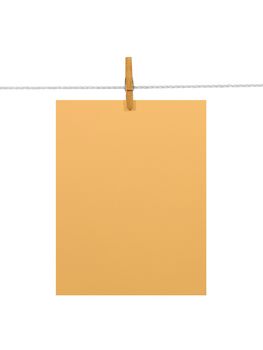 Orange blank paper sheet on a clothes line. Isolated on white background. Contains two clipping paths: 1) paper, clothes line and clothespin; 2) paper only