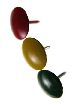 Three sharp thumbtacks representing traffic lights, on white background.